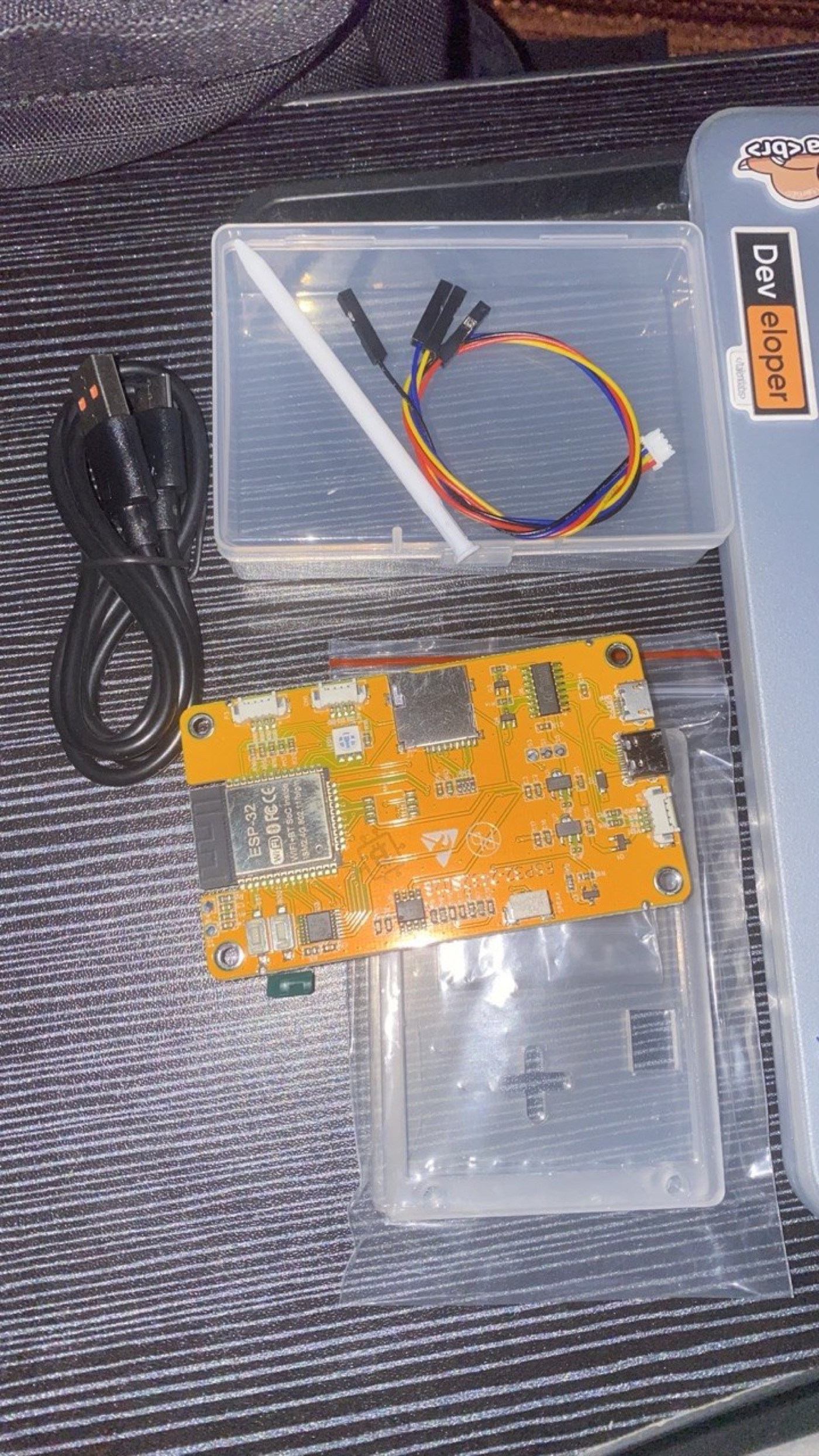 The kit as it arrived — the CYD board, a stylus, and jumper wires